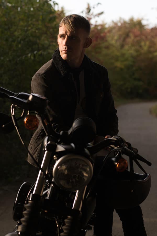 A man sitting on a motorcycle.