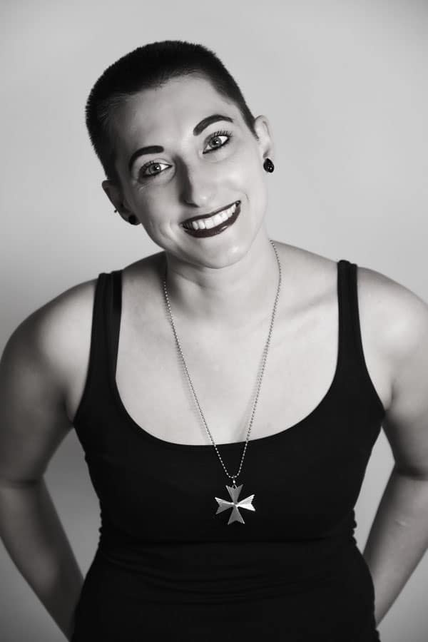 A black and white photo of a woman wearing a necklace - portrait photography by Ben Bowles
