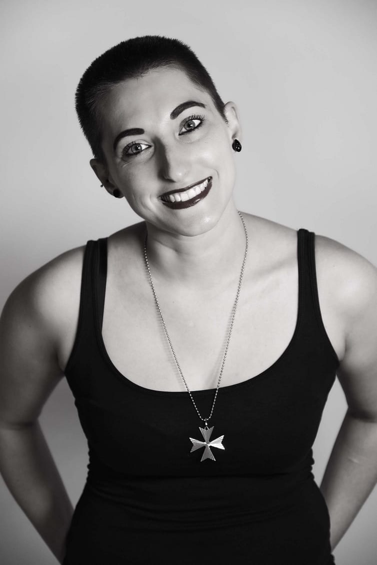 A black and white photo of a woman wearing a necklace - portrait photography by Ben Bowles