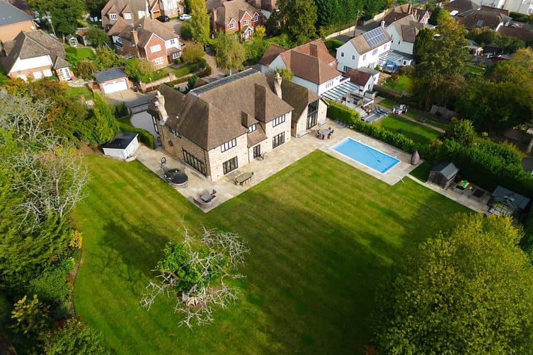 Aerial photograph of a modern Kent property, showcasing architecture and design including garden and swimming pool — drone property photography by Ben Bowles