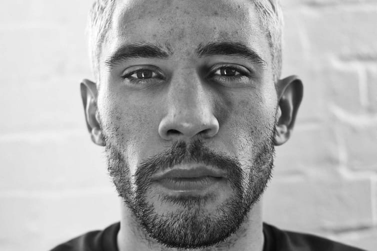 A black and white photo of a man with a beard.